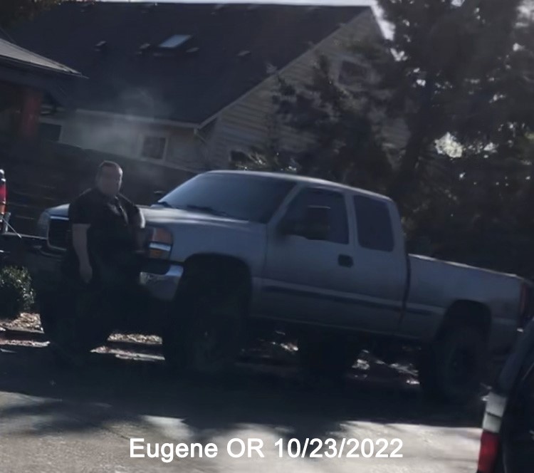 Blurry photo of Eddie Orton standing near a truck on a street in Eugene. 