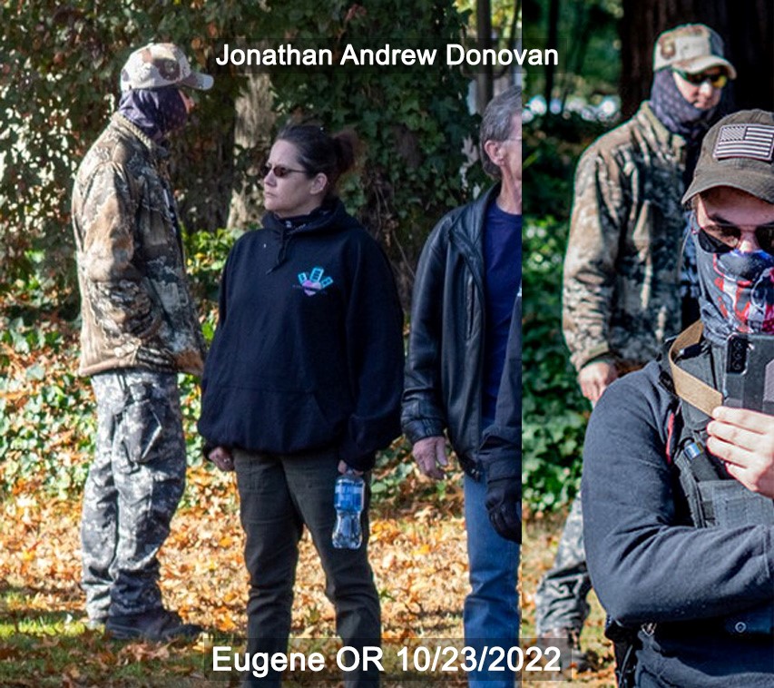 Jonathan Donovan wears an oversized realtree jacket, a dark grey gator, grey camo pants, and a light grey hat with sunglasses. 