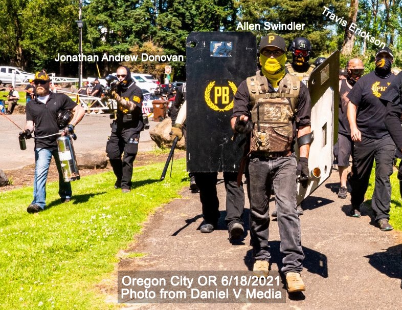 Proud Boys in Oregon City march towards the camera. One PB shield is visible. Jon Donovan holds a paintball gun. 